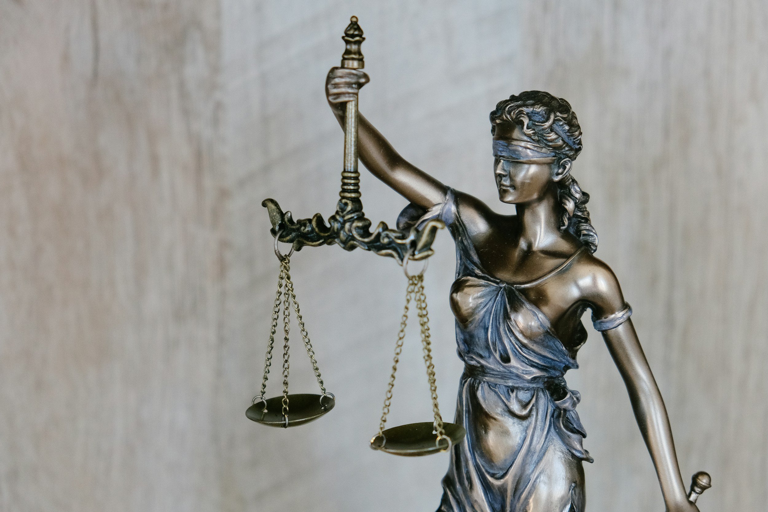 Lady Justice scales representing court judgment enforcement