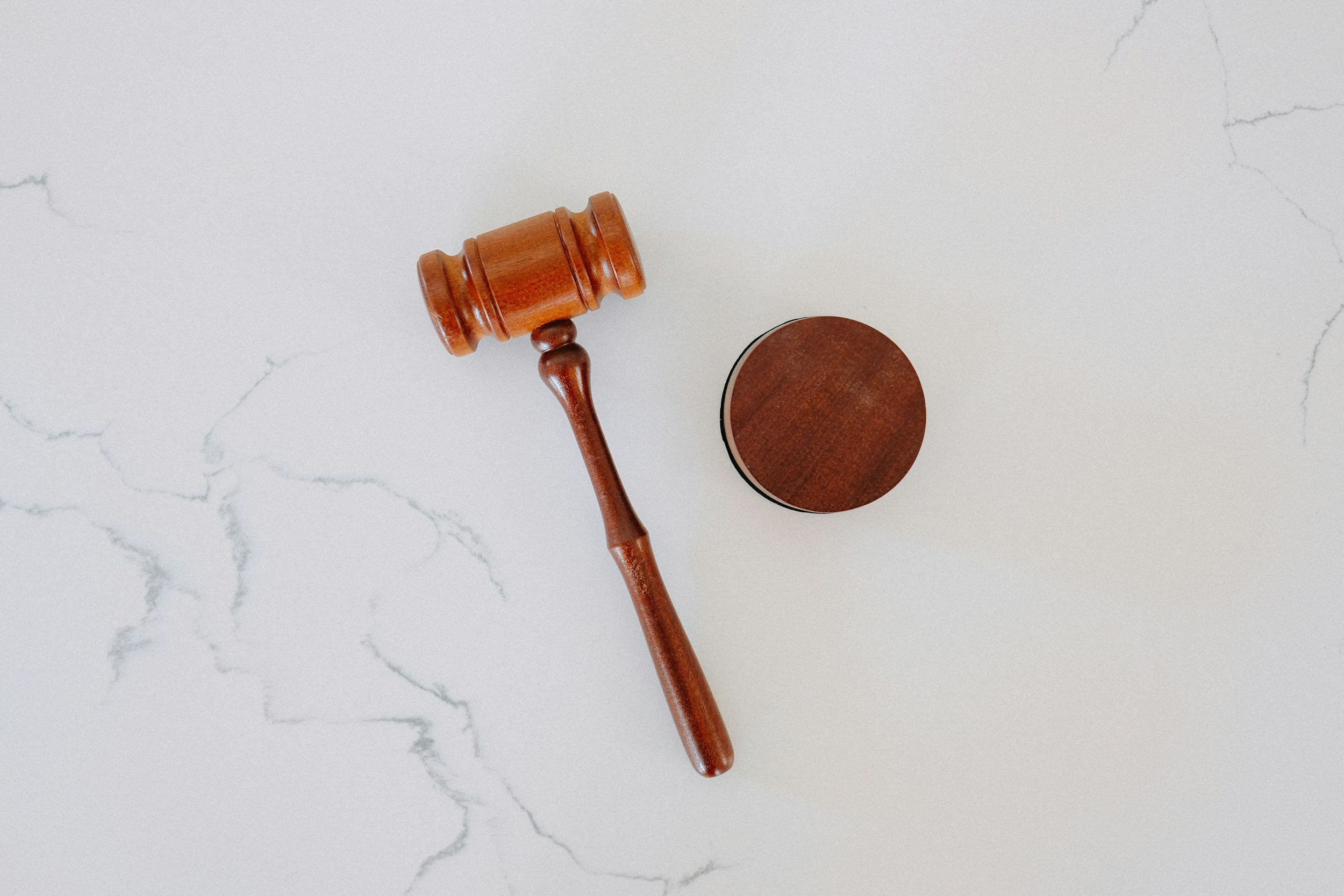 Wooden judge gavel on marble surface
